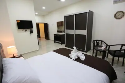 a hotel room with a bed with a towel on it at 7Boys Hotel in Amman