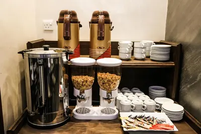 a kitchen with two blenders and cups of food at 7Boys Hotel in Amman