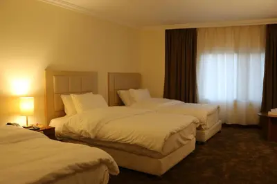 a hotel room with two beds and a window at Silk Road Hotel in Wadi Musa