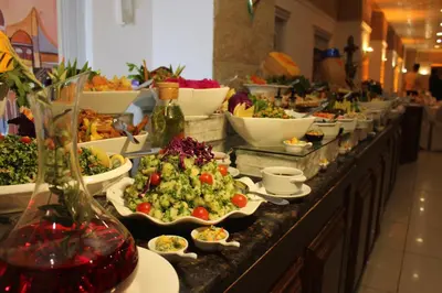 a buffet line with many plates of food on it at Edom Hotel in Wadi Musa