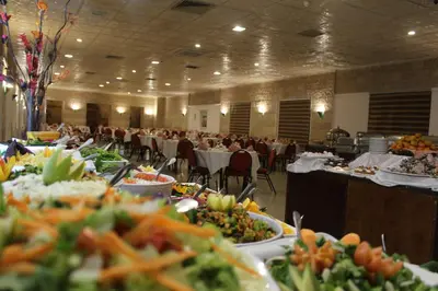 a banquet hall with many plates of food on tables at Edom Hotel in Wadi Musa