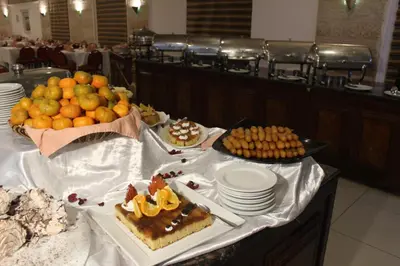a table with cakes and other food on it at Edom Hotel in Wadi Musa
