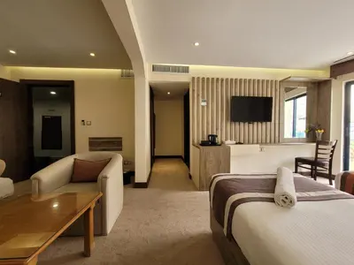 a hotel room with a bed and a living room at Edom Hotel in Wadi Musa