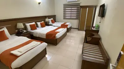 a hotel room with two beds and a television at Sunset Hotel in Wadi Musa