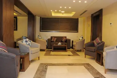 a waiting room with couches and chairs and a table at Al Raad Hotel in Aqaba