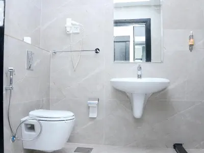 a bathroom with a white toilet and a sink at Al Raad Hotel in Aqaba