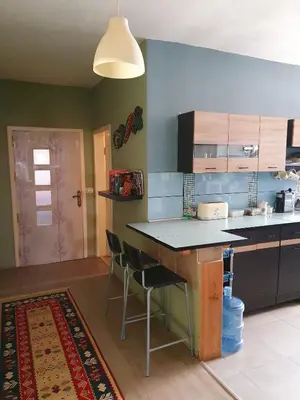 a kitchen with a counter and a table and chairs at The Little B&B on the Hill in Wadi Musa