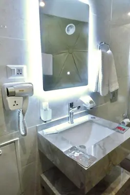 a bathroom with a sink and a mirror at Beyond Wadi Rum Camp in Wadi Rum