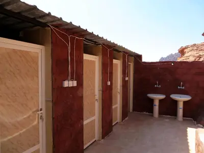a bathroom with two sinks and two toilets at Wadi Rum Bedouin Way Camp in Wadi Rum