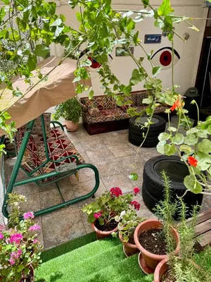 a garden with pots of flowers and plants at The Sydney Hotel in Amman