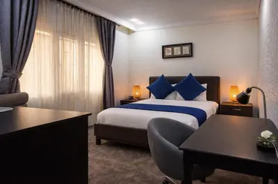 a hotel room with a bed and a desk at Al Basem Hotel in Amman