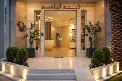 a lobby of a building with potted plants at Al Basem Hotel in Amman
