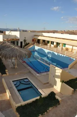 a large swimming pool next to a building at Red Sea Dive Center in Aqaba
