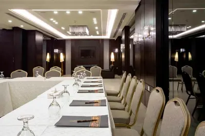 a conference room with a long table and chairs at Retaj Hotel in Amman