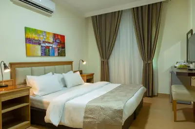 a hotel room with a large bed and a desk at 360 Hotel By FHM in Amman