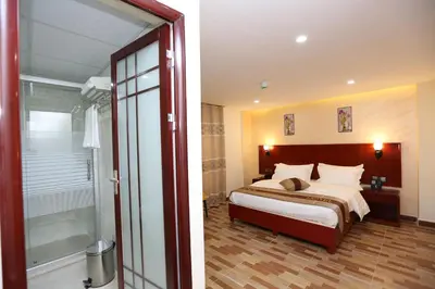 a bedroom with a bed and a walk in shower at Venus Hotel in Wadi Musa