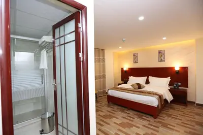 a bedroom with a bed and a sliding glass door at Venus Hotel in Wadi Musa