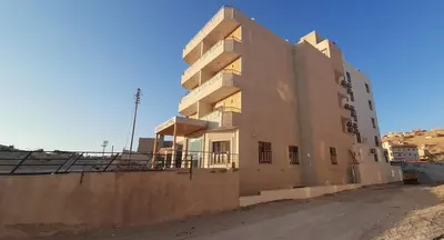 a building in the middle of a dirt road at Venus Hotel in Wadi Musa