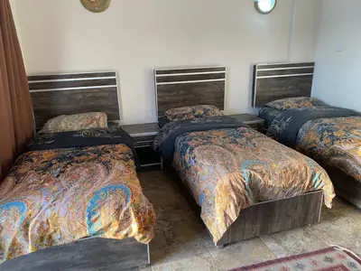 a room with three beds in a room at Aqaba Adventure Divers Resort & Dive Center in Aqaba