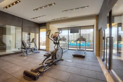 a gym with cardio equipment in a hotel room at The House Boutique Suites in Amman