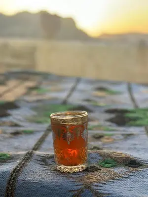 a cup sitting on top of a table at Happy Bedouin House Petra in Al Ḩayy