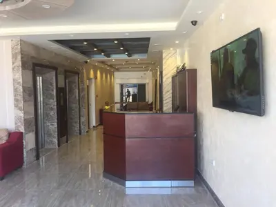 a lobby with a reception desk in a building at Al haramain Furnished Apartments in Amman