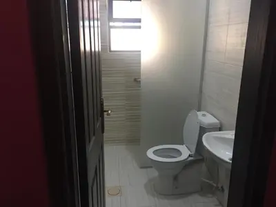 a bathroom with a toilet and a sink at Al haramain Furnished Apartments in Amman