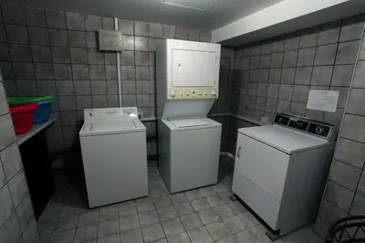 a utility room with two machines and a washer at Barakat Hotel Apartments in Amman