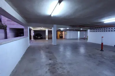 an empty parking garage with a car parked in it at Barakat Hotel Apartments in Amman