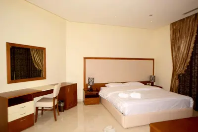 a hotel room with a bed and a desk at Public Security Hotel & Chalets in Aqaba