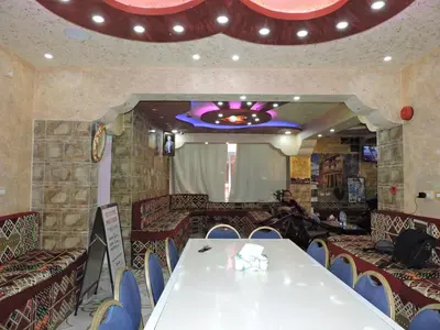 a dining room with a white table and chairs at Valentine Inn in Wadi Musa