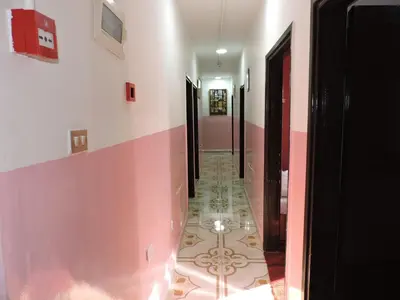 a hallway with a tile floor in a building at Valentine Inn in Wadi Musa
