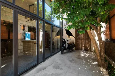 a scooter parked in front of a building with windows at Canary Boutique Hotel in Amman