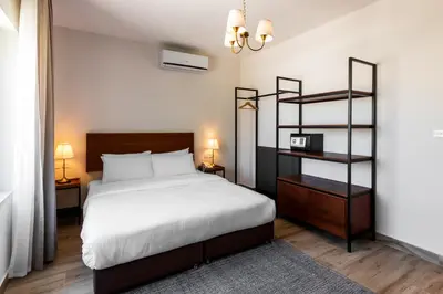 a bedroom with a bed and a book shelf at Canary Boutique Hotel in Amman