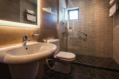 a bathroom with a sink and a toilet at Canary Boutique Hotel in Amman