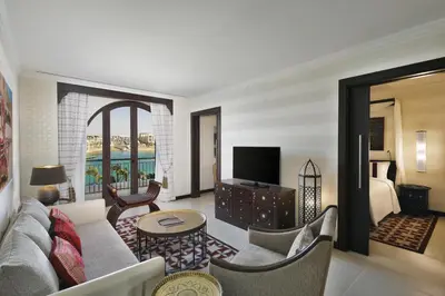 a living room with a couch and a television at Al Manara, a Luxury Collection Hotel, Aqaba in Aqaba