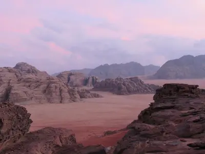 a view of the desert with mountains and rocks at Desert Rock camp in Wadi Rum