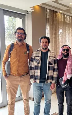 a group of three men standing in a room at Shams Alweibdeh Hotel Apartments in Amman