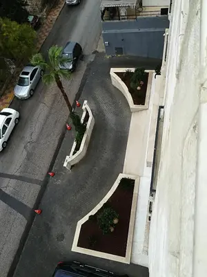 an aerial view of a street with cars and a palm tree at Shams Alweibdeh Hotel Apartments in Amman