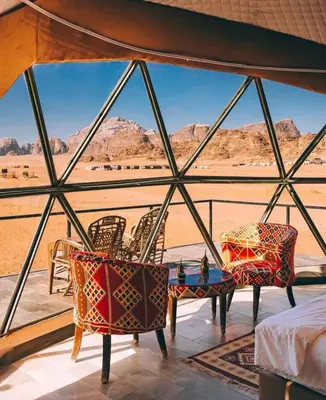 a room with a view of the desert from a tent at Hasan Zawaideh Camp in Wadi Rum