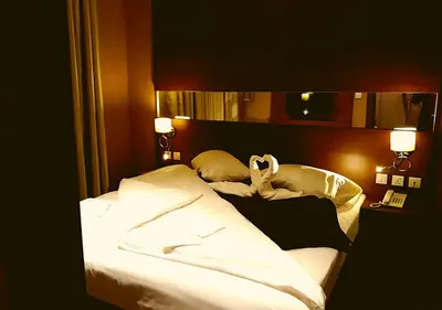 a bed with a stuffed animal laying on top of it at The Seventh Star Hotel Suites in Amman