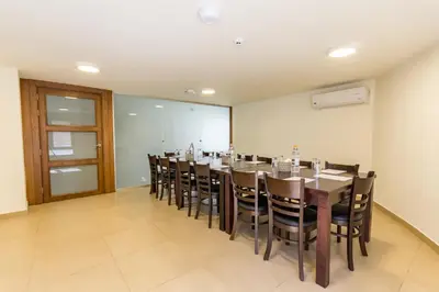 a conference room with a long table and chairs at The Seventh Star Hotel Suites in Amman