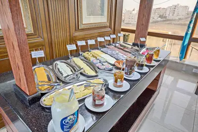 a buffet of food and drinks on a table at Amman International Hotel in Amman
