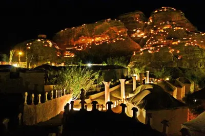 a view of a city at night with lights at Seven Wonders Bedouin Camp in Wadi Musa