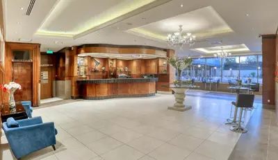 a lobby of a hotel with a bar in it at Geneva Hotel in Amman