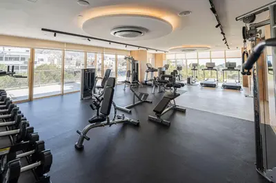 a gym with treadmills and chairs in a building at DoubleTree by Hilton Hotel Aqaba in Aqaba