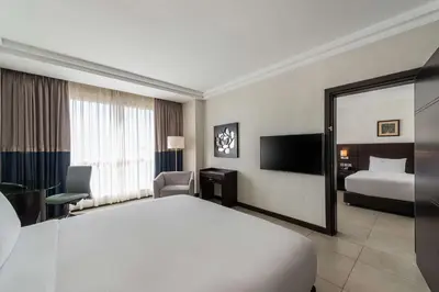 a hotel room with a large bed and a bedroom at DoubleTree by Hilton Hotel Aqaba in Aqaba