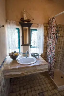 a bathroom with a sink and a shower at Beit Al Fannan in Ţabaqat Faḩl