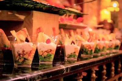 a row of cups filled with food on a counter at Hayat Zaman Hotel And Resort Petra in Wadi Musa