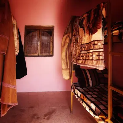 a room with two bunk beds and a window at MalakoRum in El Quweira